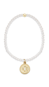 A gold beaded stretch bracelet with a circular medallion charm featuring a cross, displayed on a clean white background.