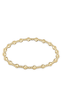 A gold beaded stretch bracelet featuring alternating polished round beads and smaller textured barrel beads, displayed in a horizontal oval shape on a clean white background.