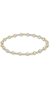 A delicate beaded bracelet featuring alternating polished yellow gold and textured silver beads, arranged in an oval shape against a solid white background.