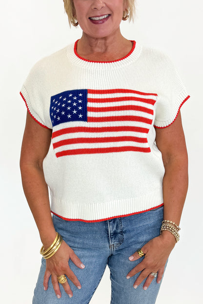 Front detail view of woman wearing Swagger Boutique’s  Sleeveless Patriot Sweater In Cloud by Z Supply with jeans and sandals against white studio background.