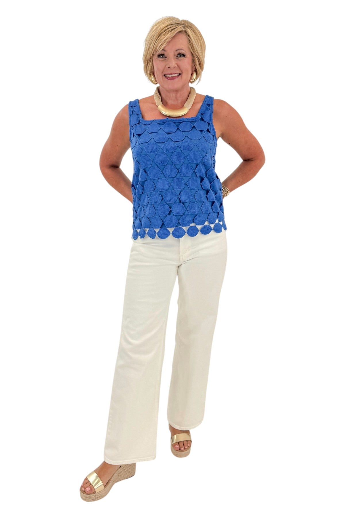 Front view of woman wearing Swagger Boutique’s Cobalt Sleeveless Lace Tank with jeans against white studio background.