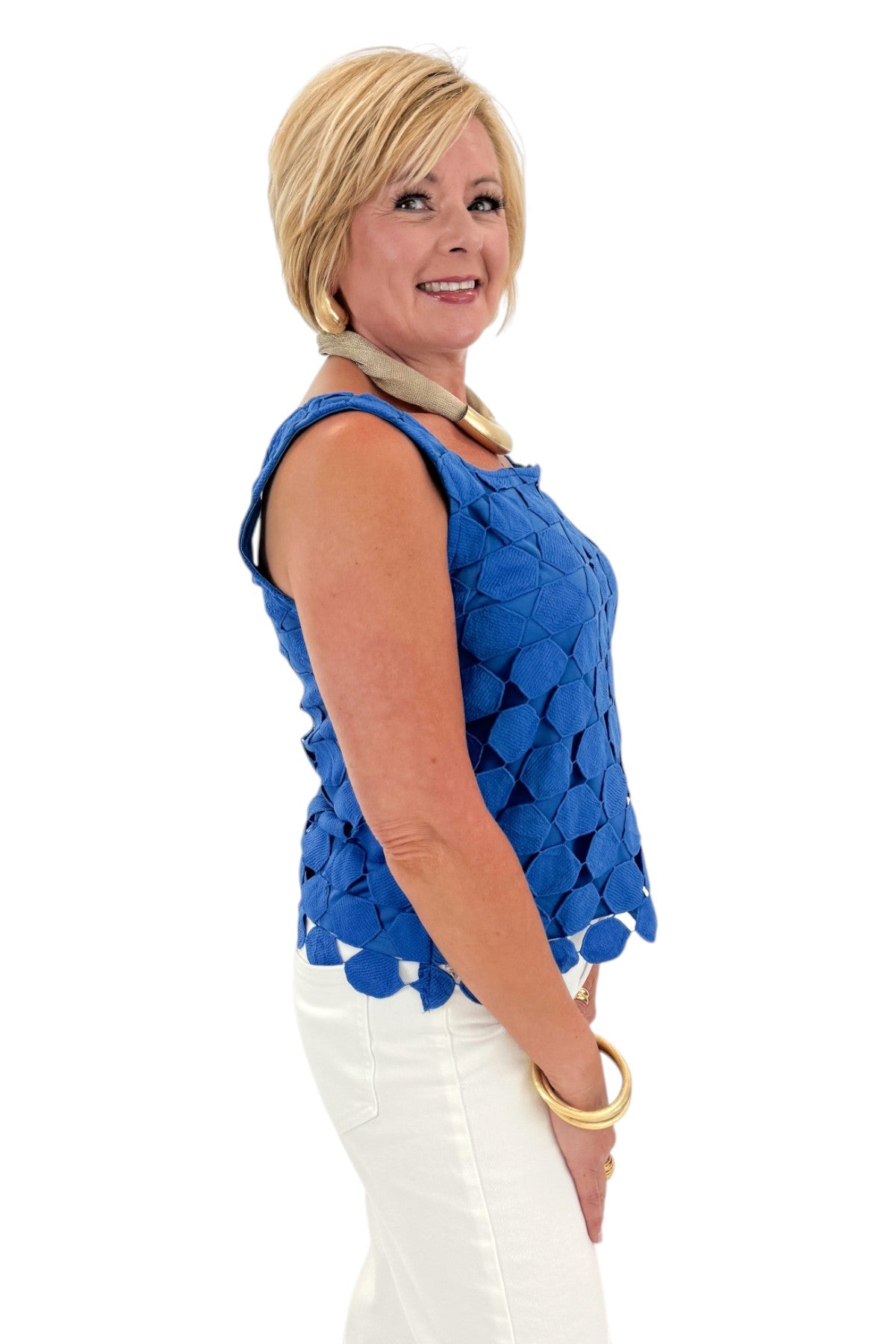 Side view of woman wearing Swagger Boutique’s Cobalt Sleeveless Lace Tank with jeans against white studio background.