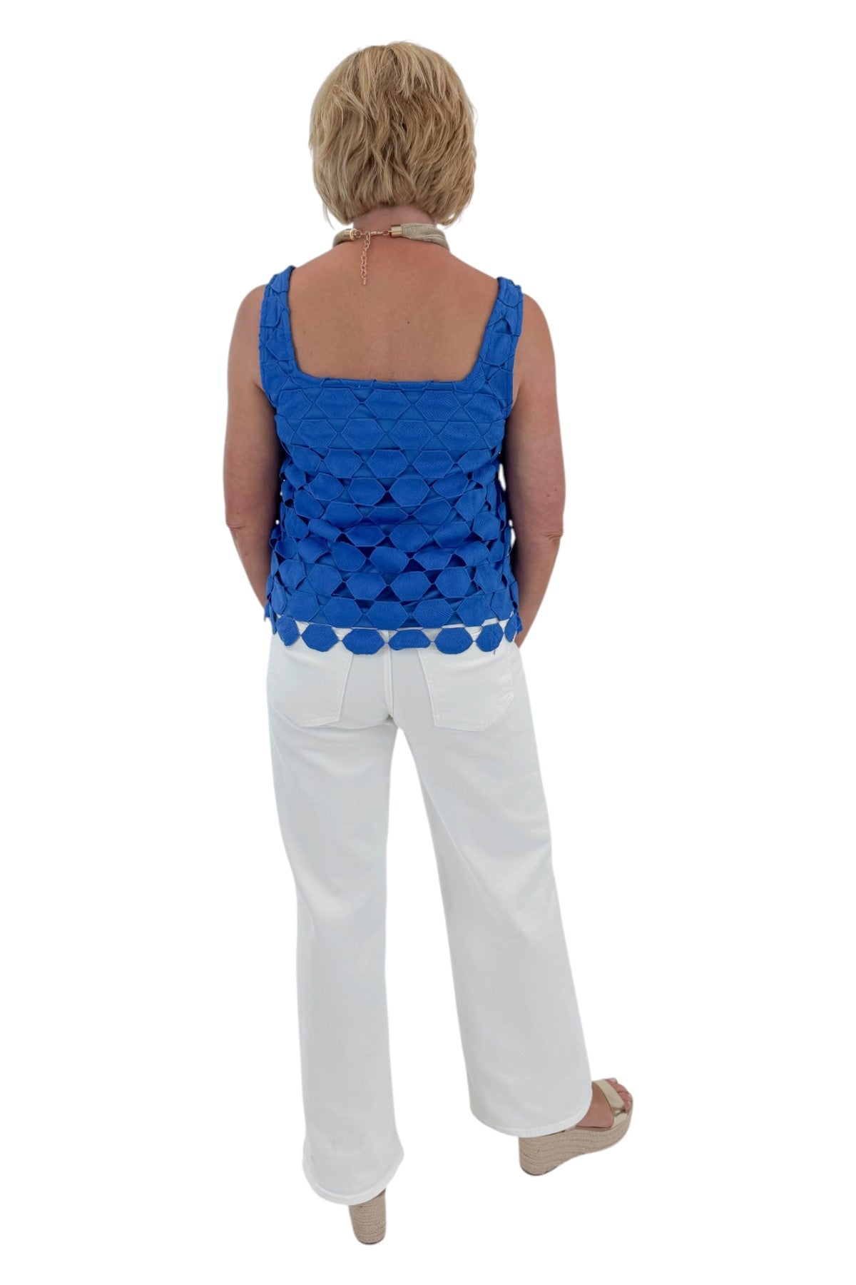 Back view of woman wearing Swagger Boutique’s Cobalt Sleeveless Lace Tank with jeans against white studio background.