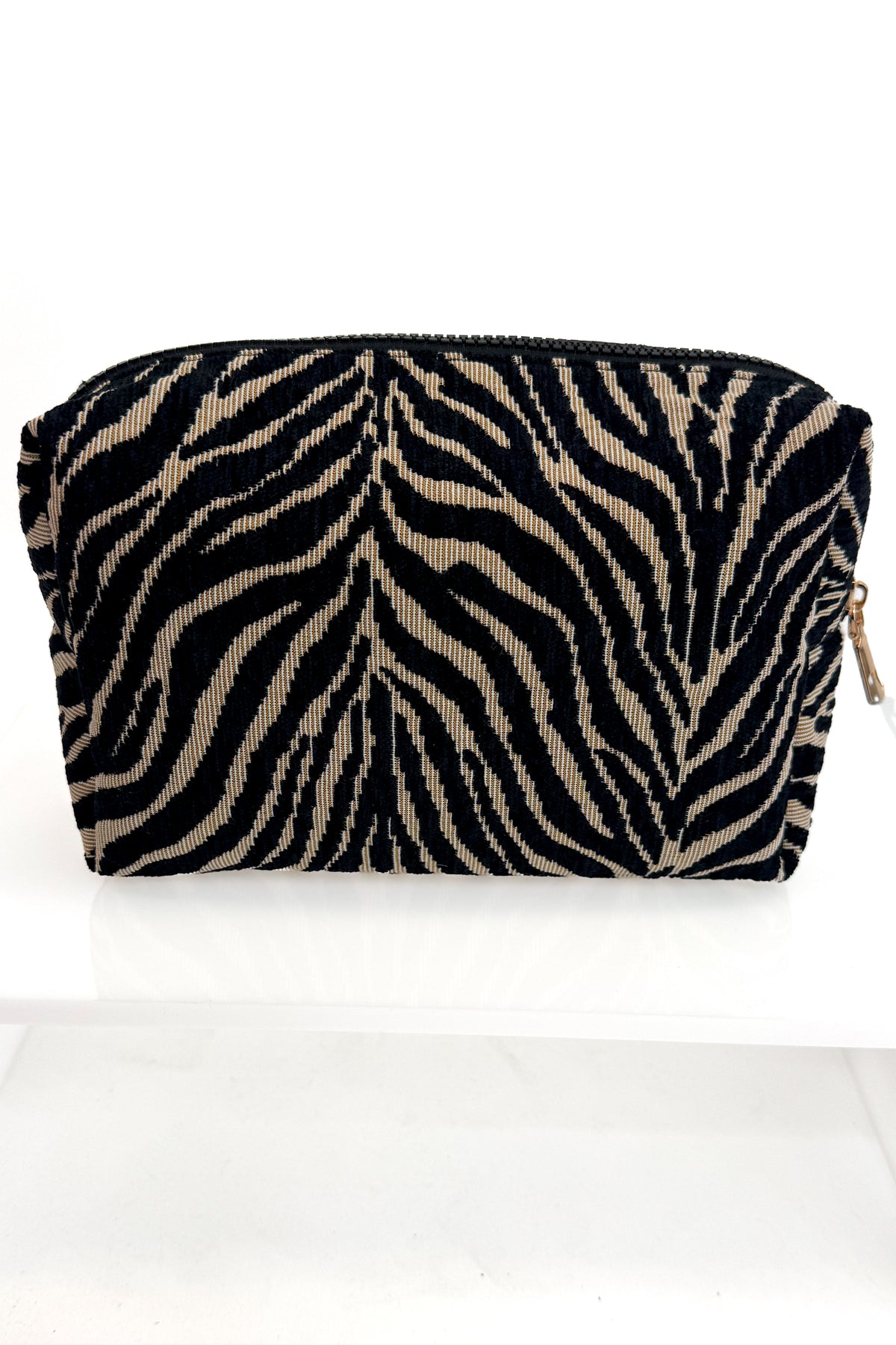 A small zippered pouch with a black and beige zebra stripe pattern, shown on a plain white background.