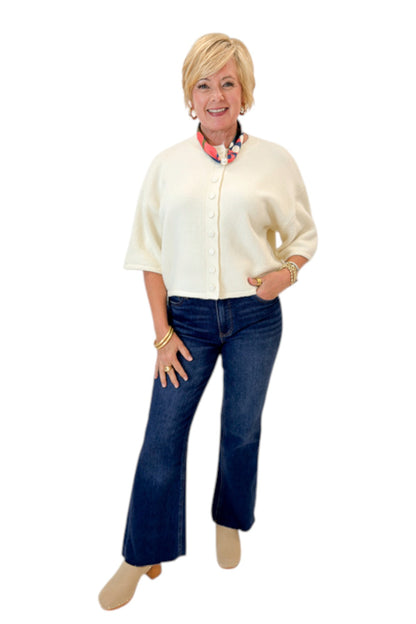Front view of woman wearing Swagger Boutique’s Cream Button Down Short Sleeve Sweater by PINCH with jeans against white studio background.