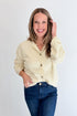 Front view of woman wearing Swagger Boutique’s Cream Button Up Cardigan with jeans against white studio background.