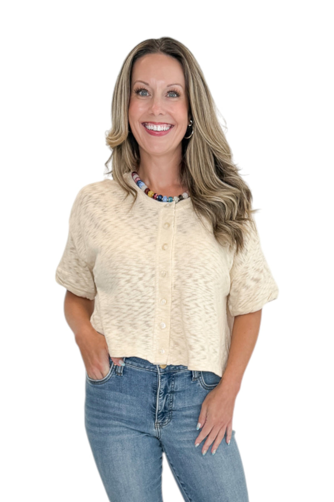 Front view of woman wearing Swagger Boutique’s Cream Button Up Short Sleeve Sweater with jeans against white studio background.
