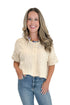 Front view of woman wearing Swagger Boutique’s Cream Button Up Short Sleeve Sweater with jeans against white studio background.