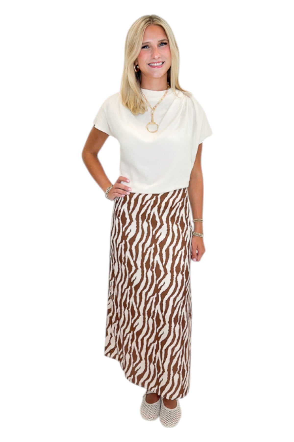 Front view of woman wearing Swagger Boutique’s Cream Cowl Neck Top with Camel Zebra Print Midi Skirt against white studio background.