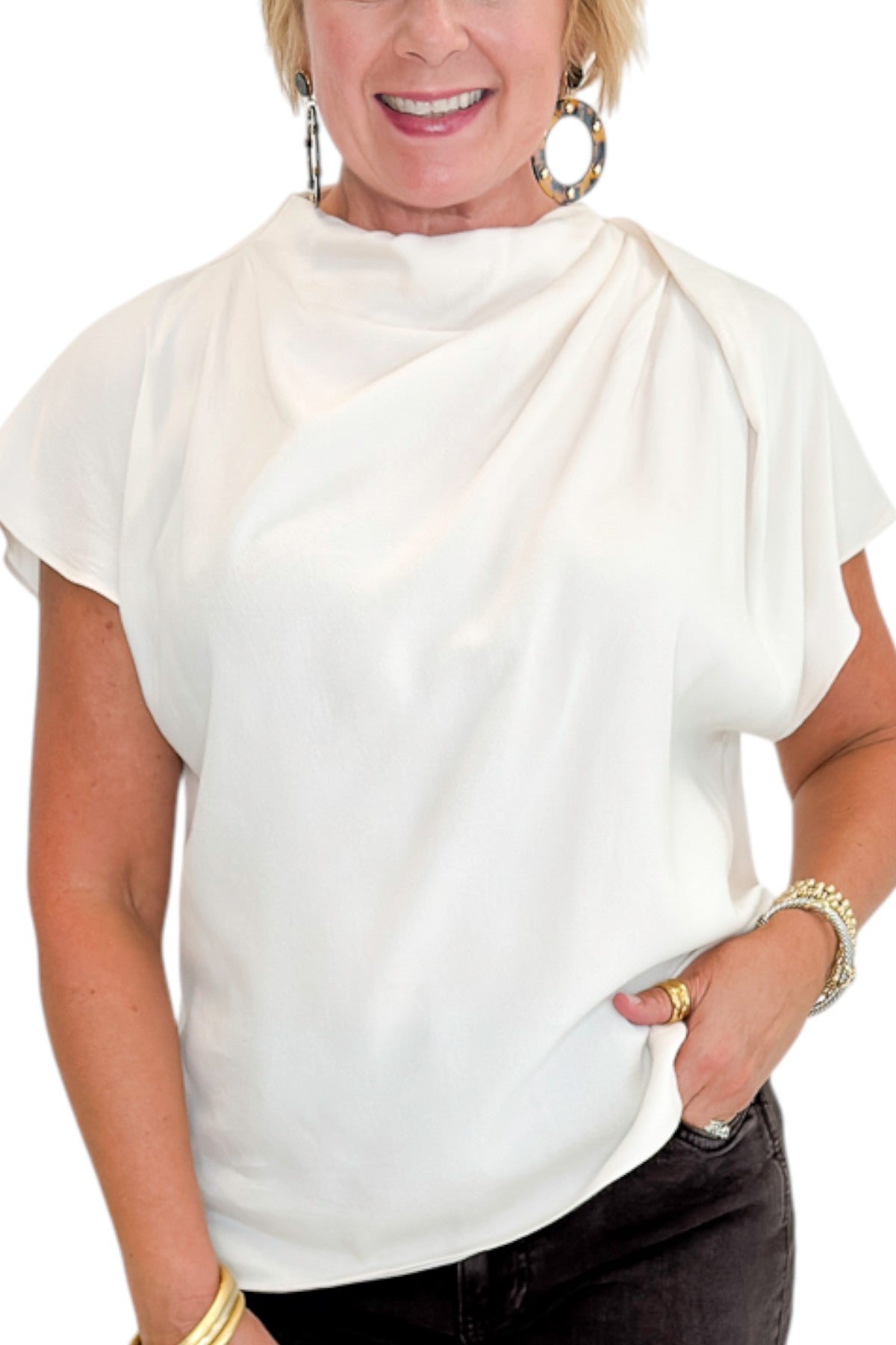 Front detail view of woman wearing Swagger Boutique’s Cream Cowl Neck Top with jeans against white studio background.
