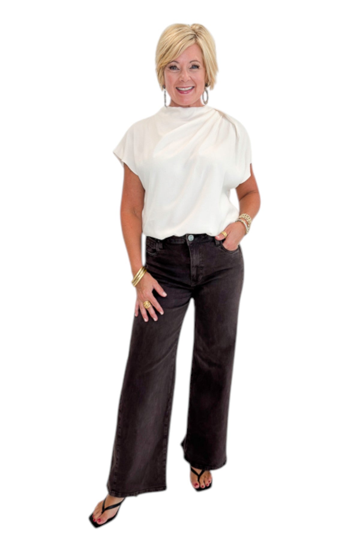 Front view of woman wearing Swagger Boutique’s Cream Cowl Neck Top with jeans against white studio background.
