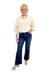 Front view of woman wearing Swagger Boutique’s Cream Elastic Hem Sweatshirt with jeans against white studio background.