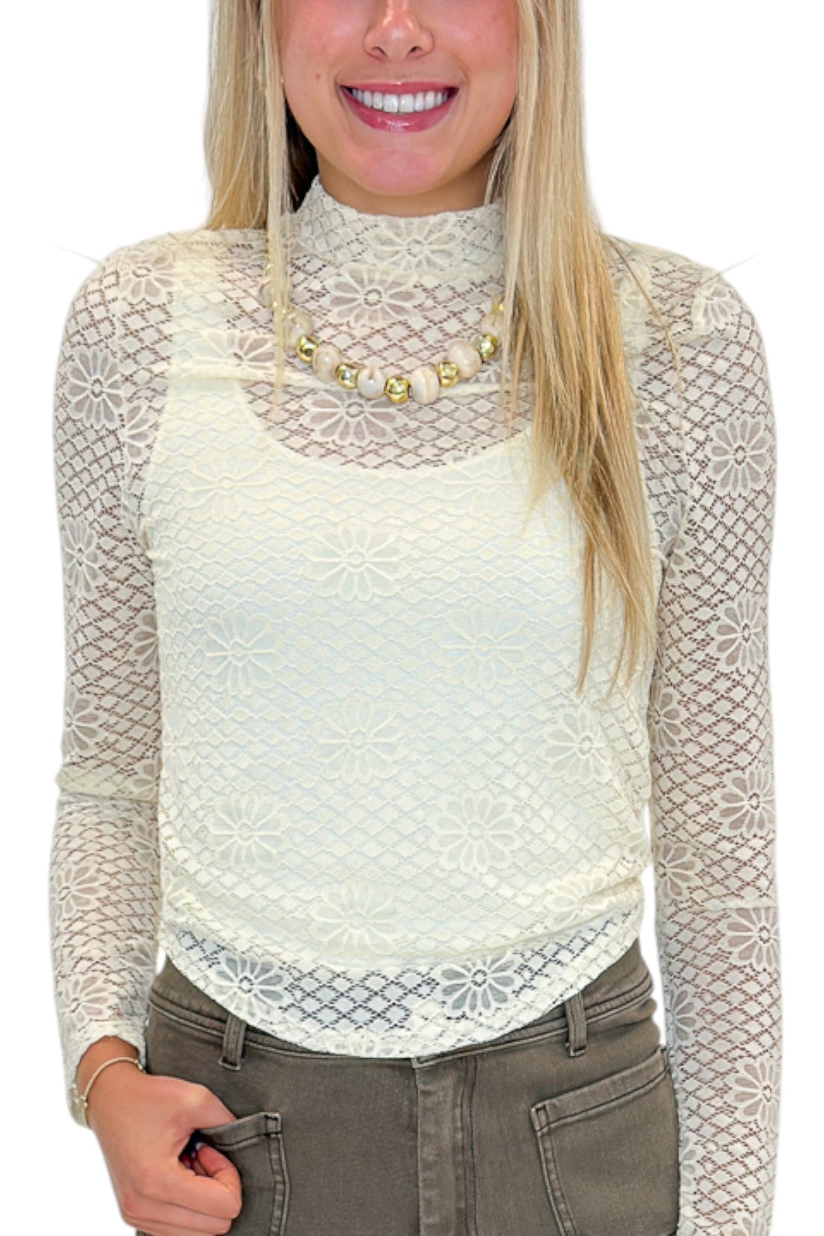 Front detail view of woman wearing Swagger Boutique’s Cream Floral Lace Top with jeans against white studio background.