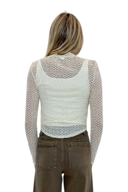 Back view of woman wearing Swagger Boutique’s Cream Floral Lace Top with jeans against white studio background.