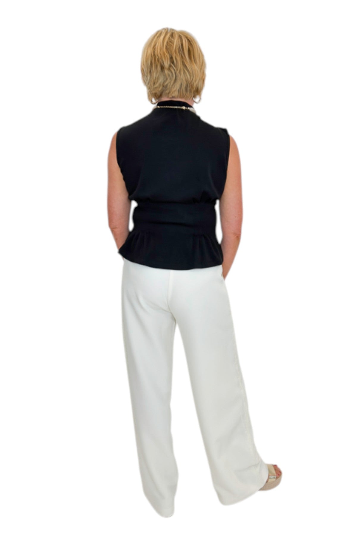 Back view of woman wearing Swagger Boutique’s Cream Lace Lined Pants with top against white studio background.