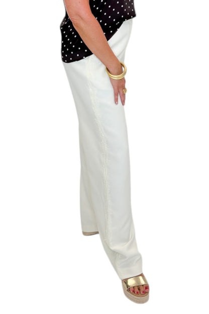 Side view of woman wearing Swagger Boutique’s Cream Lace Lined Pants with top against white studio background.