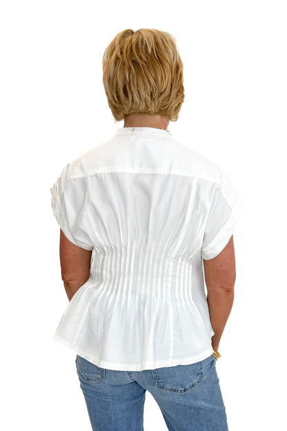 Back view of woman wearing Swagger Boutique’s Cream Pintuck Waist Top with jeans against white studio background.