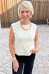 Front view of woman wearing Swagger Boutique’s Cream Pocket Detail Tank with jeans standing outside.