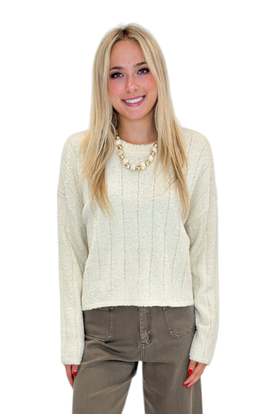 Front view of woman wearing Swagger Boutique’s Cream Ribbed Textured Sweater with jeans against white studio background.