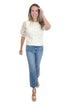 Front view of woman wearing Swagger Boutique’s Cream Sheer Sleeve Sweater with jeans against white studio background.