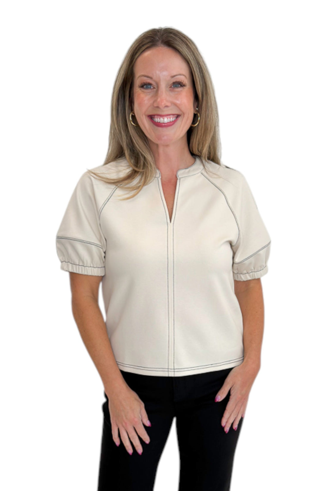 Front view of woman wearing Swagger Boutique’s Cream Stitch Detail Top with jeans against white studio background.
