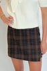 Front detail view of woman wearing Swagger Boutique’s Cream Tie Neck Short Sleeve Sweater by Entro with Brown Plaid Mini Skirt against white studio background.