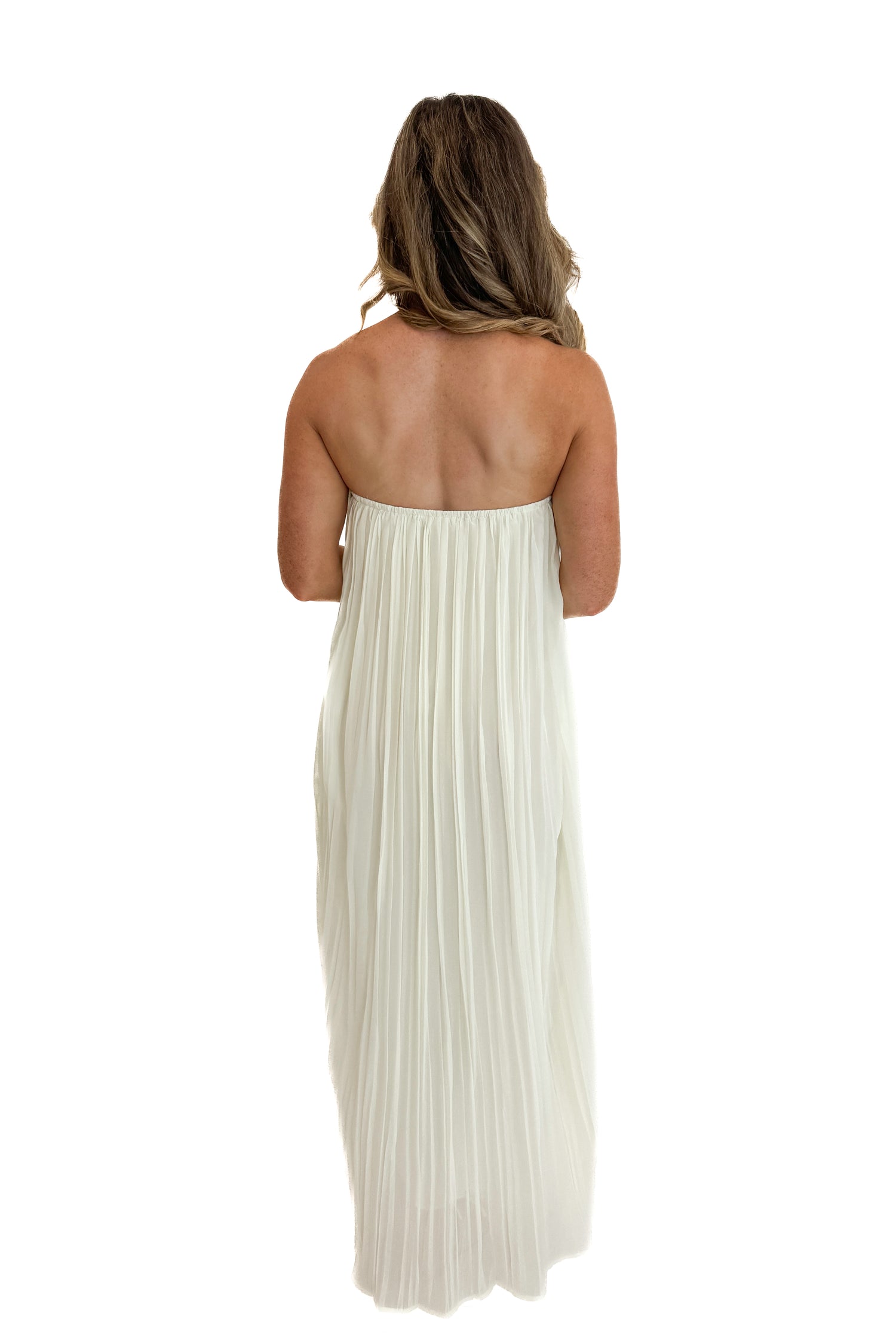 Back view of woman wearing Swagger Boutique’s Cream With Large Floral Print Pleat Detail Maxi Dress with sandals against white studio background.