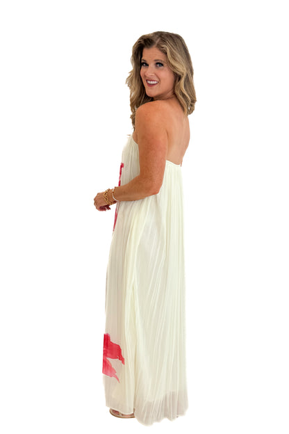 Side view of woman wearing Swagger Boutique’s Cream With Large Floral Print Pleat Detail Maxi Dress with sandals against white studio background.