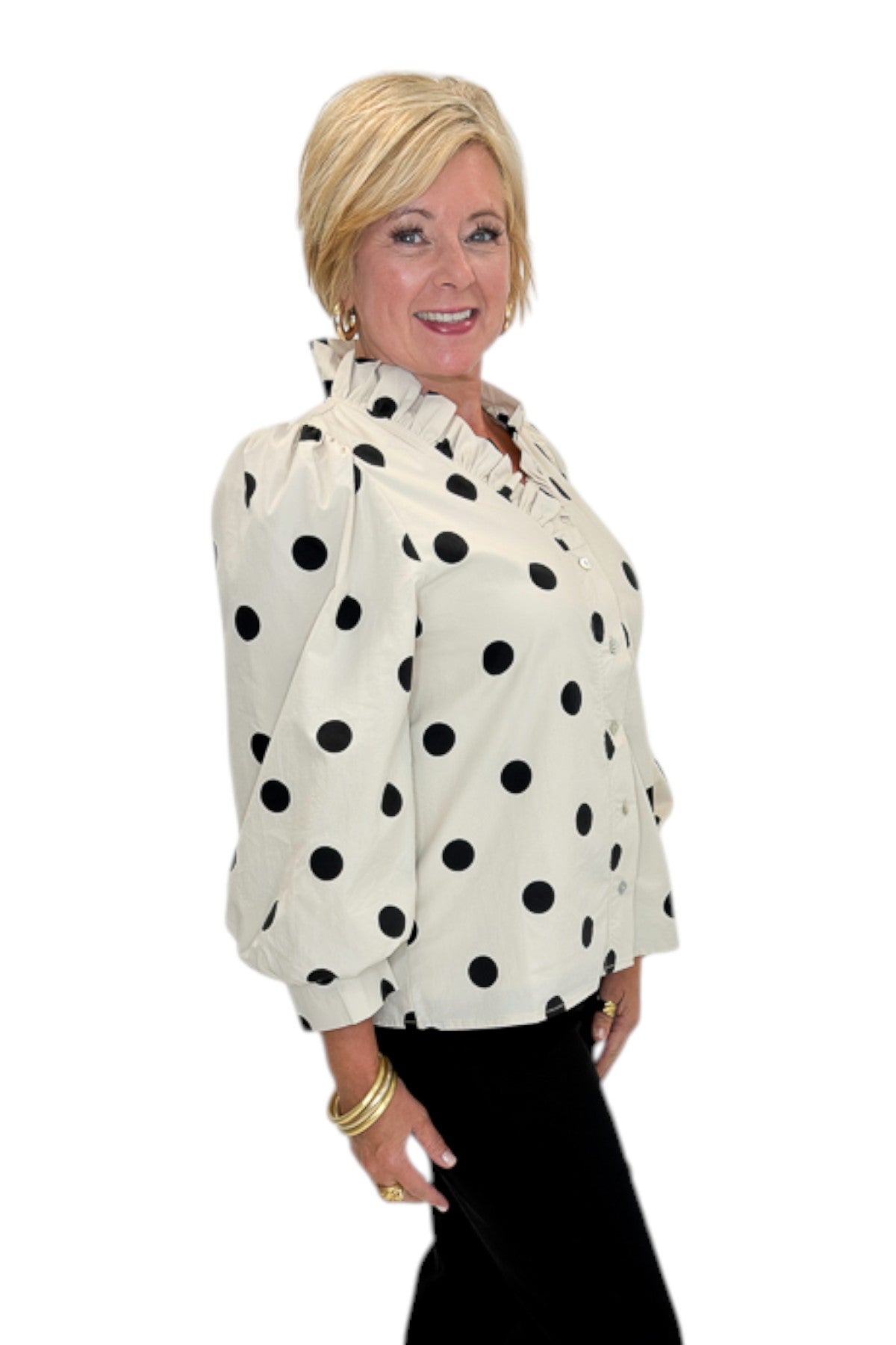 Side view of woman wearing Swagger Boutique’s Cream &amp; Black Polka Dot 3/4 Sleeve Top with Kelsey Black Denim Jeans against white studio background.