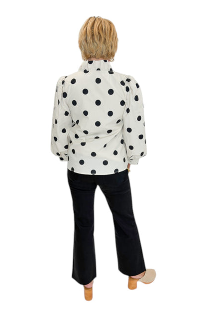 Back view of woman wearing Swagger Boutique’s Cream &amp; Black Polka Dot 3/4 Sleeve Top with Kelsey Black Denim Jeans against white studio background.