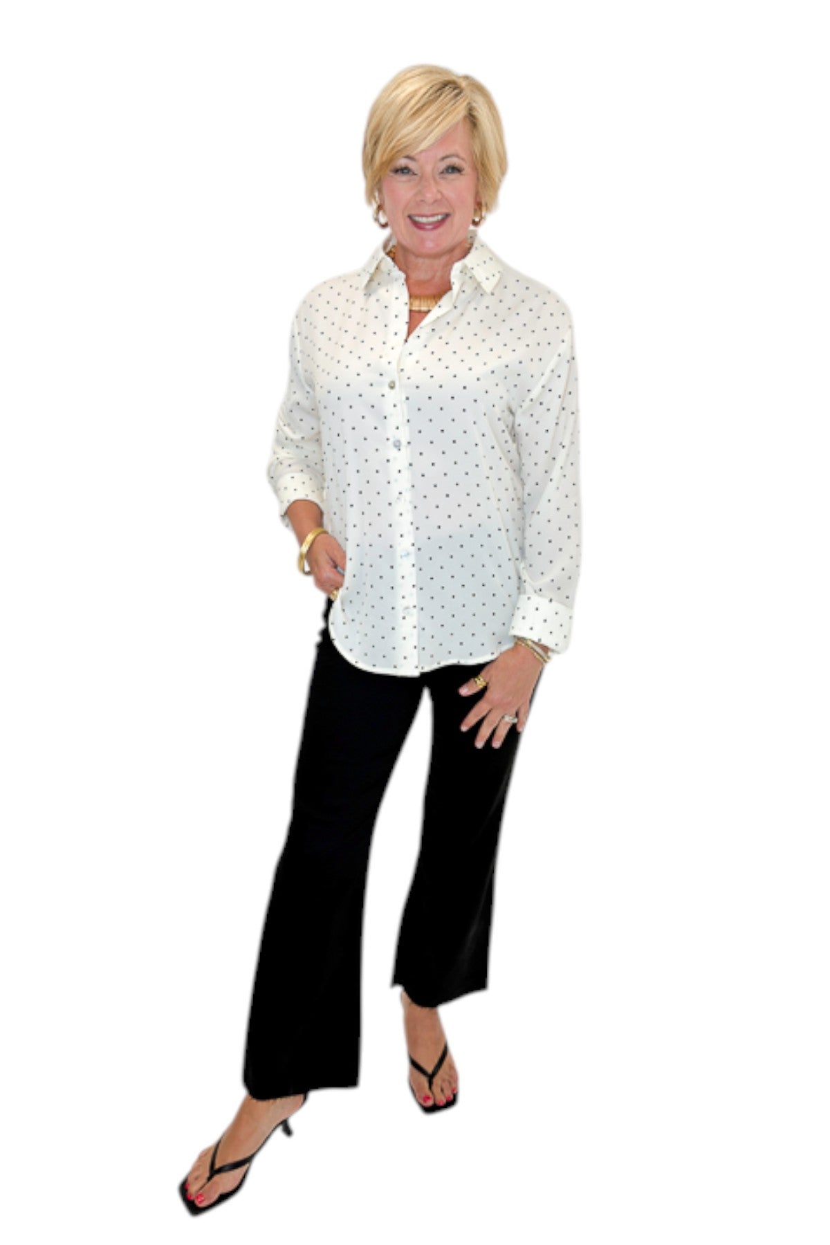 Front view of woman wearing Swagger Boutique’s Cream &amp; Black Polka Dot Satin Button Up Top with jeans against white studio background.