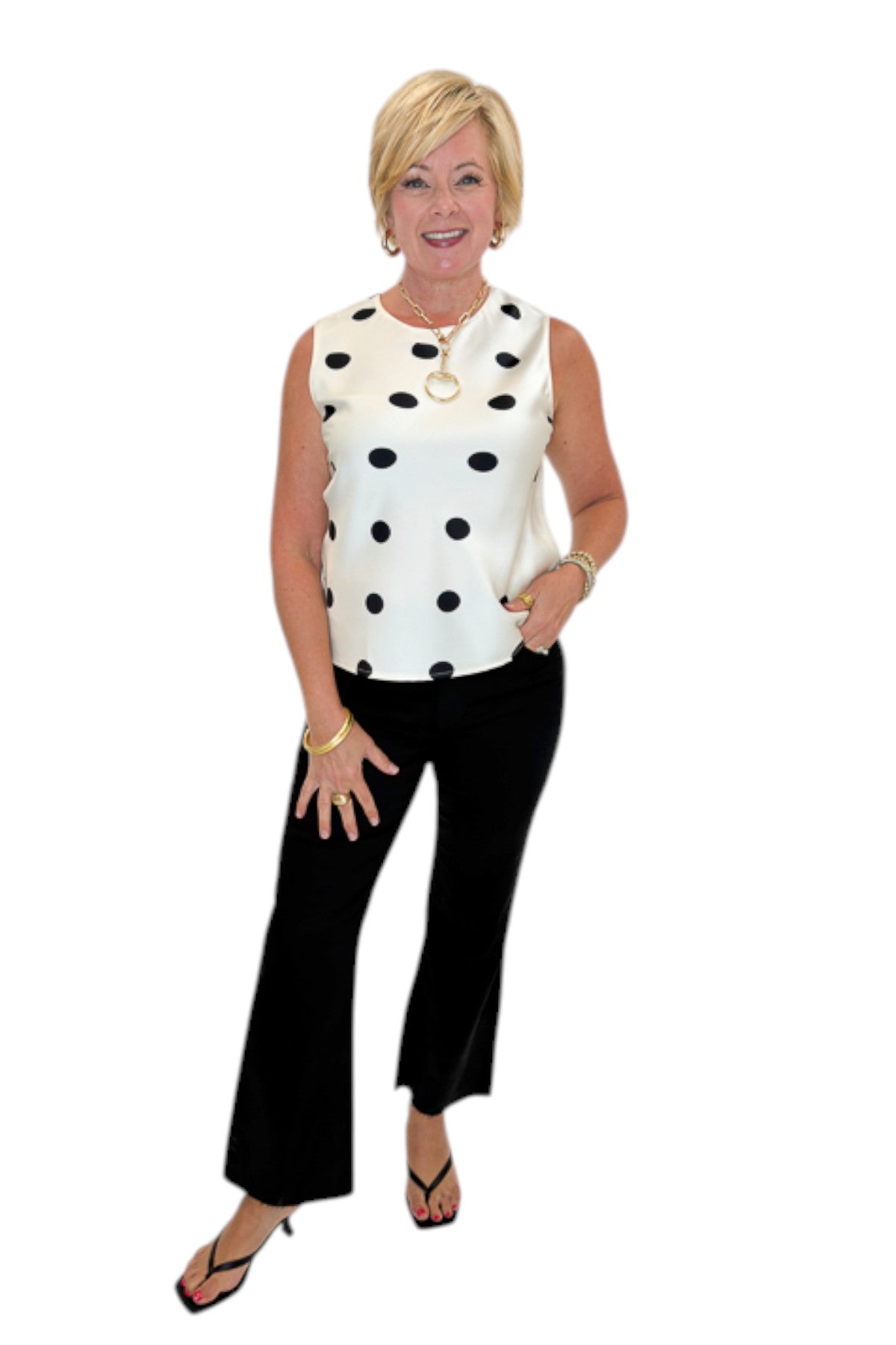 Front view of woman wearing Swagger Boutique’s Cream &amp; Black Polka Dot Satin Tank with jeans against white studio background.