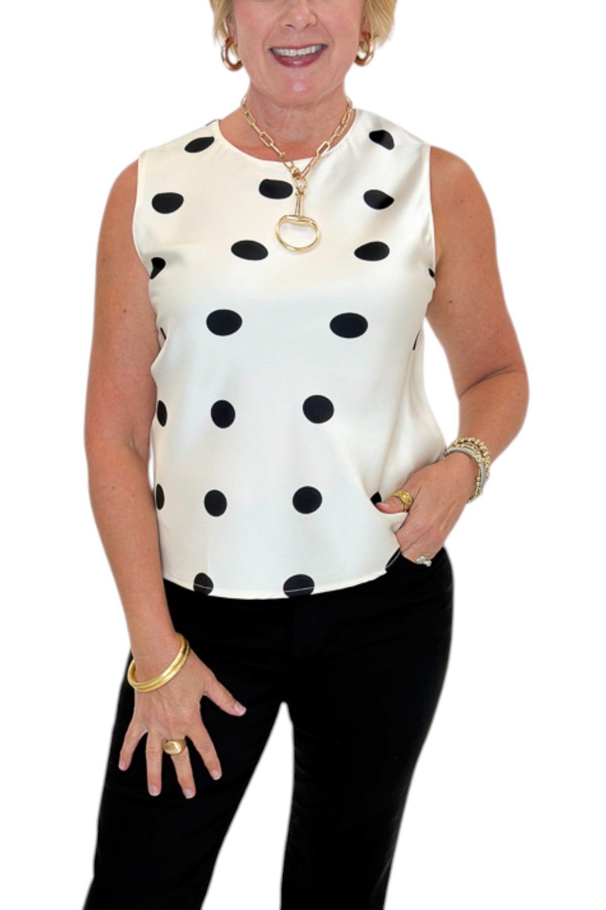 Front detail view of woman wearing Swagger Boutique’s Cream &amp; Black Polka Dot Satin Tank with jeans against white studio background.