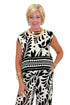 Front view of woman wearing Swagger Boutique’s Cream & Black Printed Tank & Wide Leg Pants against white studio background.