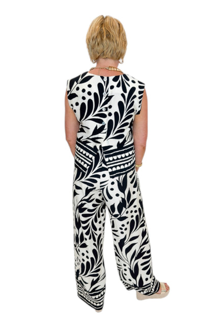 Back view of woman wearing Swagger Boutique’s Cream &amp; Black Printed Tank &amp; Wide Leg Pants against white studio background.