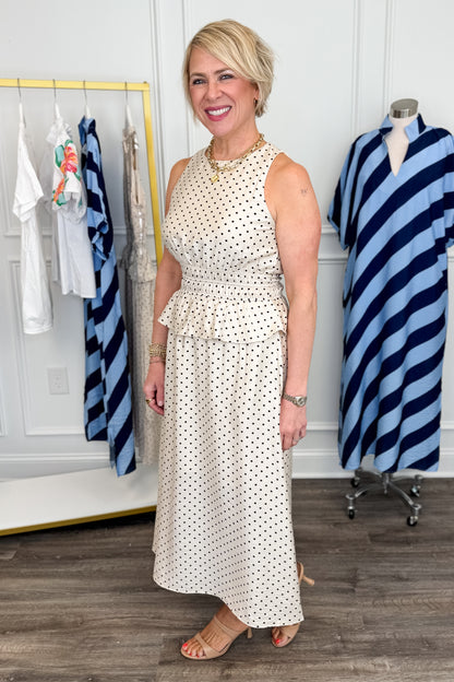 Side picture of woman wearing Cream &amp; Black Polka Dot Ruffle Detail Midi Dress with heels.