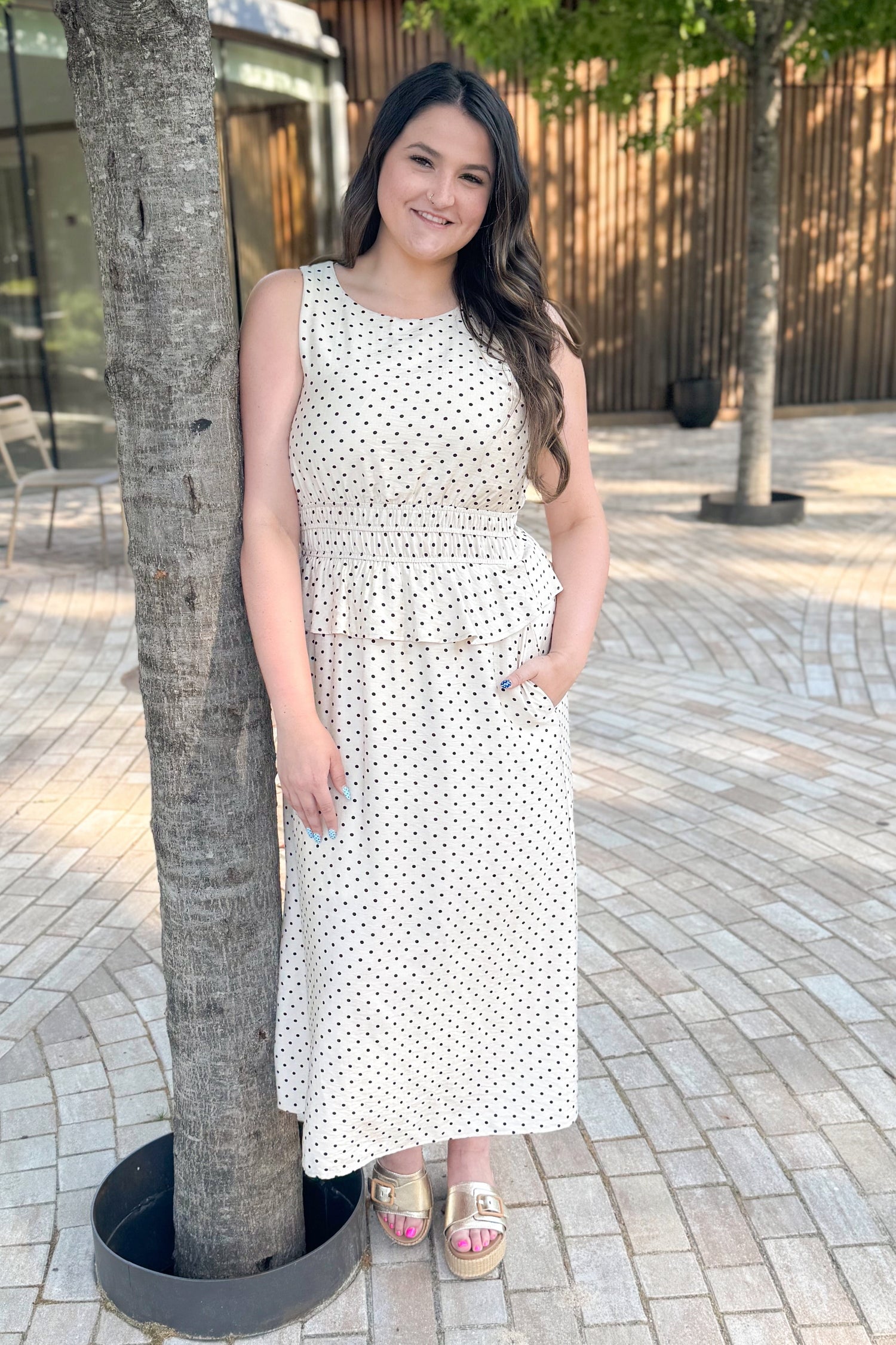 Front picture of woman wearing Cream &amp; Black Polka Dot Ruffle Detail Midi Dress with sandals standing outside.