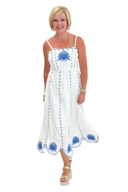 Front view of woman wearing Swagger Boutique’s Cream &amp; Blue Shell Embroidered Midi Dress with sandals against white studio background.