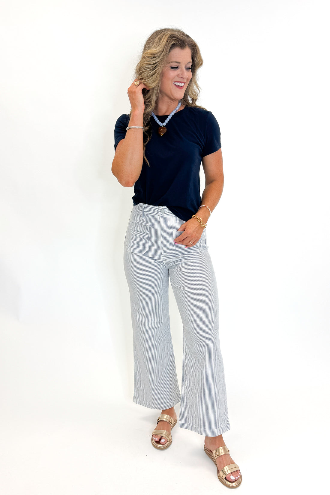 Front view of woman wearing Swagger Boutique’s Cream &amp; Blue Striped Jeans With Patch Pocket by Just Black Denim with blue Z Supply top against white studio background.
