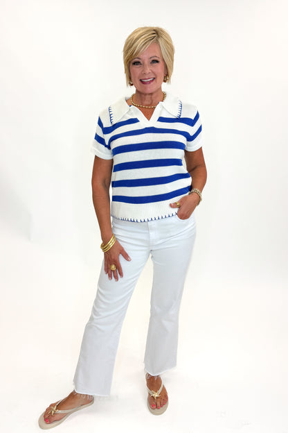 Front view of woman wearing Swagger Boutique’s Cream &amp; Blue Striped Knit Top by Skies Are Blue with jeans against white studio background.