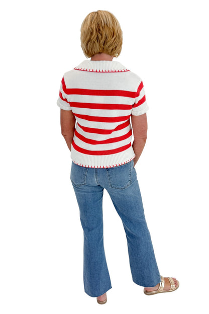 Back view of woman wearing Swagger Boutique’s Cream &amp; Coral Striped Knit Top with jeans against white studio background.