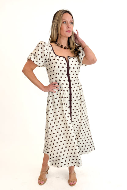 Front view of woman wearing Cream With Brown Stripe Detail Polka Dot Midi Dress by Entro against white studio background.