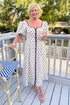 Front view of woman wearing Cream With Brown Stripe Detail Polka Dot Midi Dress by Entro outside at a restaurant.