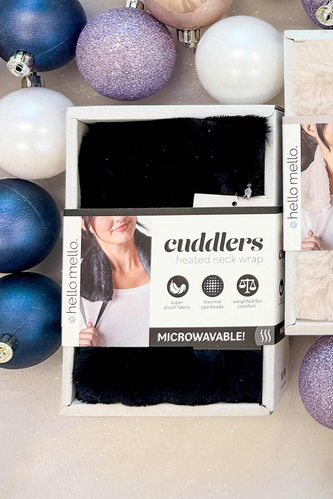 Cuddlers Heated Neck Wrap against holiday background black