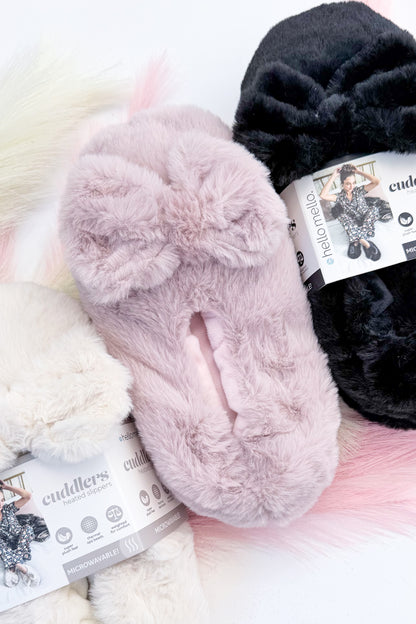 Cuddlers Heated Slippers against studio background.