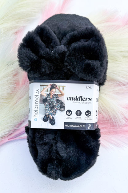 Cuddlers Heated Slippers against studio background-black