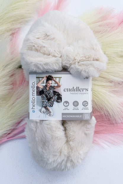 Cuddlers Heated Slippers against studio background-ivory