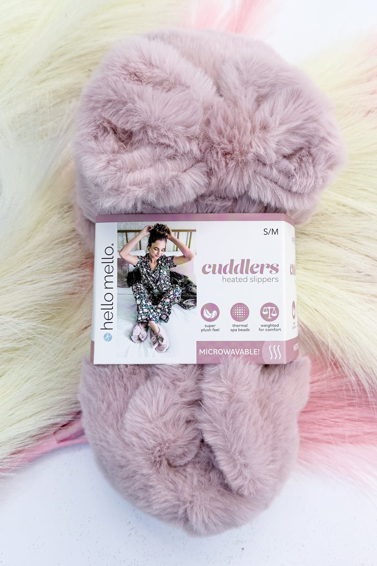 Cuddlers Heated Slippers against studio background-light pink.