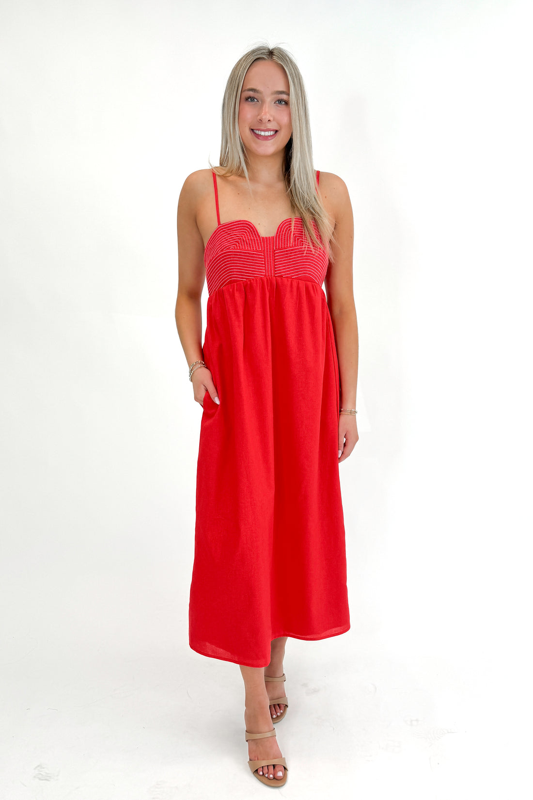 Front view of woman wearing Red Top Stitch Midi Dress against white studio background.