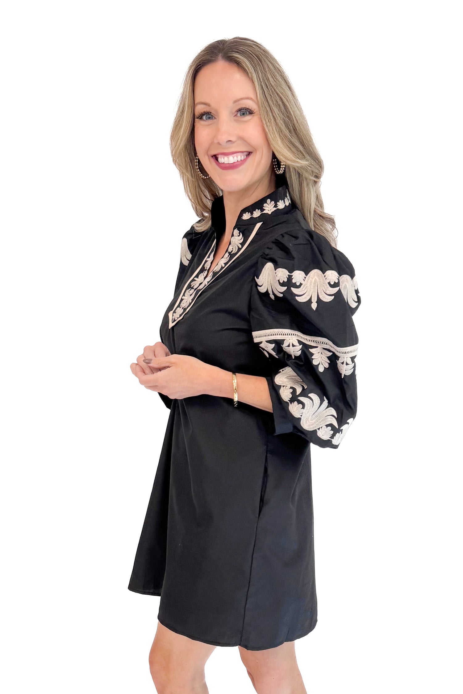 Side view of woman in Black With Cream Embroidery Puff Sleeve Dress by Entro. 